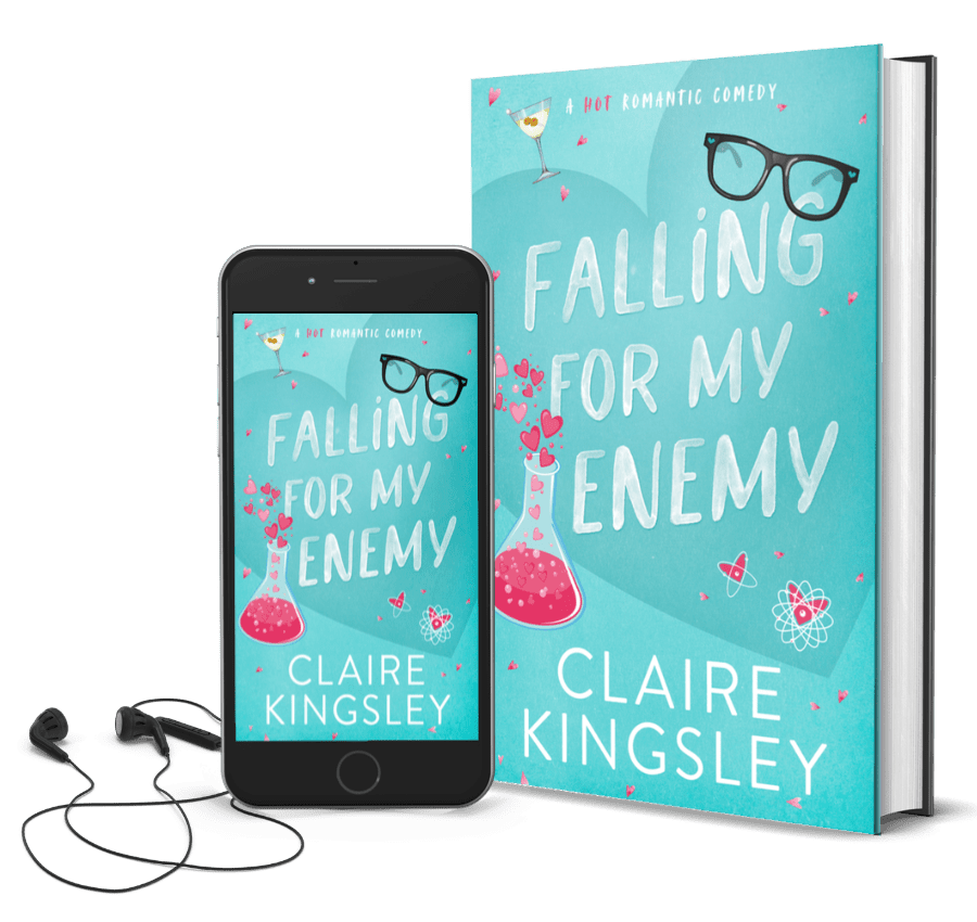 The book cover for Falling for My Enemy, a hot romantic comedy by Claire Kingsley, is a teal background with illustrated images of a pair of black framed glasses, a science beaker with pink liquid and hearts spilling out, and a martini glass. Next to the book is a phone showing the cover with a pair of wired earbuds.