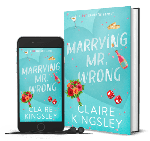 The book cover for Marrying Mr Wrong, a hot romantic comedy by Claire Kingsley, is a teal background with illustrated images of a bought of roses, red dice with hearts, a champagne bottle, wedding bands and a martini glass. Next to the book is a phone showing the cover with a pair of wired earbuds.