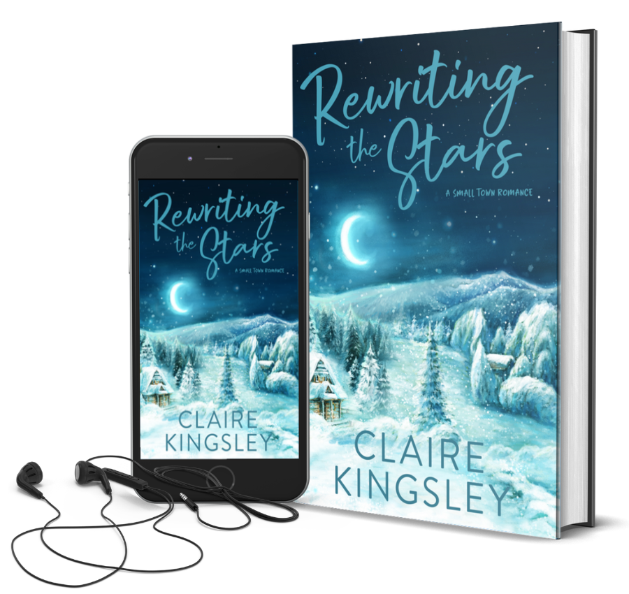 The book cover for Rewriting the Stars, a small-town romance by Claire Kingsley, is an illustrated image at night of a log cabin surrounded by pine trees, a mountain range in the distance, and everything is covered in a deep layer of pure white snow. In the sky the moon is shining bright as snowflakes are falling. Next to the book is a phone showing the cover with a pair of wired earbuds.