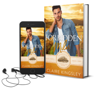 The book cover for Forbidden Miles, a small-town romance by Claire Kingsley, is an image of a dark haired man standing with one hand resting on the back of his neck and a small smirk on his face, a vineyard at sunset in the background. There are shades of yellow and white. Next to the book is a phone showing the cover with a pair of wired earbuds.