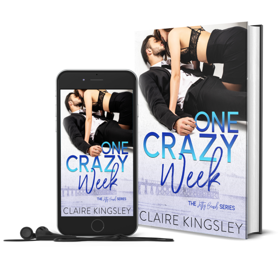 The book cover for One Crazy Week, a small-town romance by Claire Kingsley, is an image of a bearded man with brown hair laying on his back while a woman crawls on top of him, her long dark brown hair falling to one side as she leans down for a kiss. There are shades of dark and light blue. Next to the book is a phone showing the cover with a pair of wired earbuds.